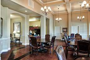 A large room with a long table and chairs.