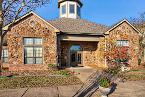 A house with a stone facade and a tower.