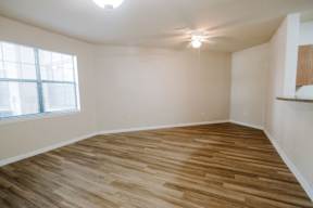 A room with wooden flooring and a ceiling fan.