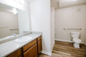 A bathroom with a white toilet and a sink.