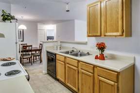 A kitchen with wooden cabinets and a white countertop.