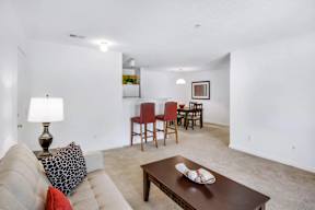 A living room with a couch, chairs, and a coffee table.