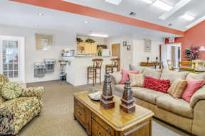 A living room with a couch, chairs, and a coffee table.