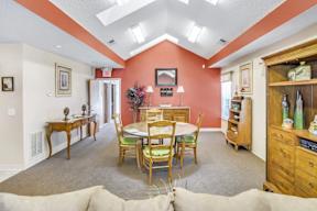 A dining room with a table set for six.