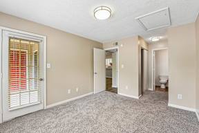A room with a carpeted floor and a ceiling light.
