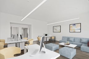 a living room with couches and a desk with a computerat Metropolis Apartments, Glen Allen, VA 23060