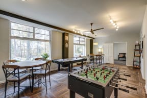 a game room with a foosball table and tables