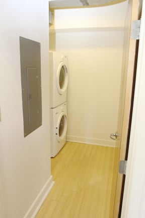 a small laundry room with a washer and dryer in a door