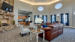 a living room with couches and chairs and a fireplace