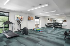 a workout room with treadmills and other exercise equipment at Crossline, Columbus, 43201
