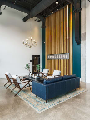 a view of the living room with a blue couch and white chairs at Crossline, Columbus