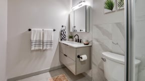 Walk-In Showers With Built-In Bench And Glass Enclosure at Residences at Richmond Trust, Richmond