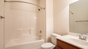 a bathroom with a shower and a sink and a toilet