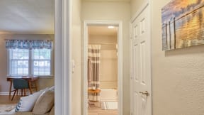 a bedroom with a bed and a chair in a room