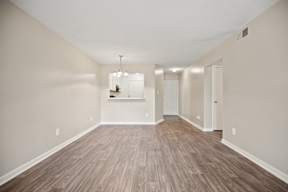 A room with wooden floors and a chandelier.