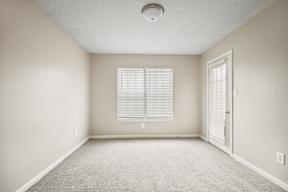 A room with a window and a door.