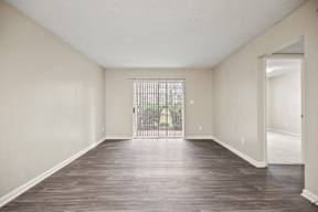 A room with wooden floors and white walls.