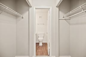 A white toilet is in a small white bathroom.