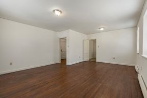 A room with wooden floors and white walls.