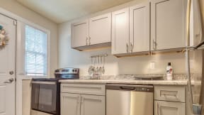 a kitchen with white cabinets and granite countertops