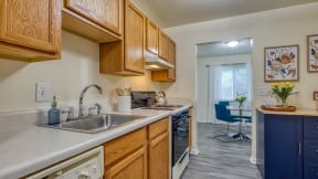view of kitchen with sink and stove and dining room with table and chair and window