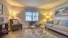 a living room with a couch chair and coffee table