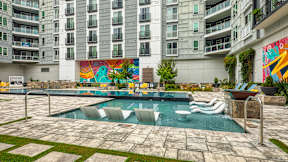 A large mural in a courtyard with a pool at Mosaic Summit Pointe in Chesapeake, VA
