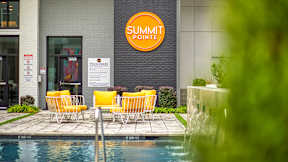 A pool area with chairs and a sign that says Summit Pointe at Mosaic Summit Pointe in Chesapeake, Virginia, 23320