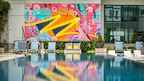 A pool with a mural on the wall behind it at Mosaic Summit Pointe in VA, 23320