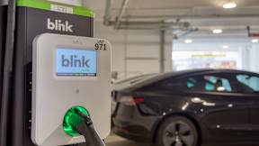 A Blink charging station is plugged into a car at Evening at Mosaic Summit Pointe VA, 23320
