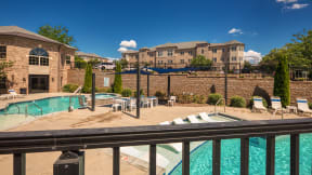 our apartments have a resort style pool with chairs and tables