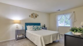 a bedroom with a bed and a window