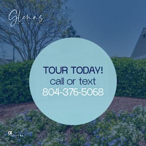 A sign in front of a hedge advertises a tour and provides a phone number.