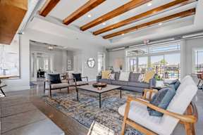 A living room with a wooden floor and a large window.
