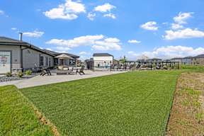 A grassy field with a building in the background.