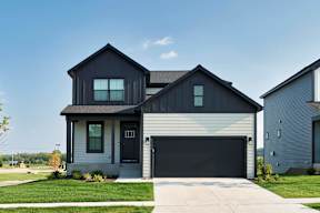 A modern house with a black garage door.