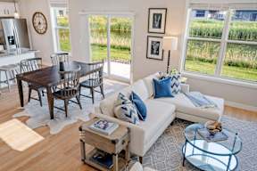 A living room with a white couch and a wooden coffee table.
