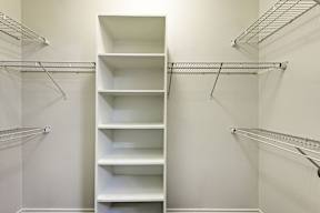 Empty white shelves on the wall.