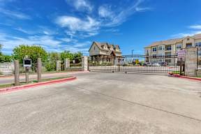 The image shows a gated entrance to a residential area with a sign that reads "Waterhouse Ranch."