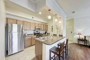 A modern kitchen with a large island and wooden cabinets.