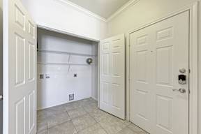A white door is on the right and a white closet door is on the left.