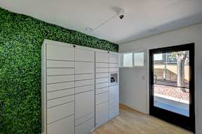 A room with a green wall and a white cabinet.