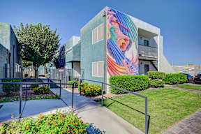 A modern building with a colorful mural on the side.