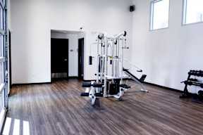 A gym with a variety of equipment including a leg press machine.