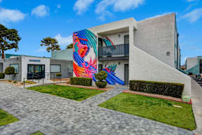A modern building with a colorful mural on the side.