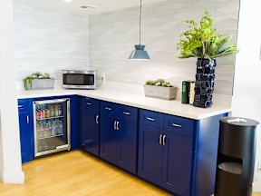 A kitchen with blue cabinets and a white countertop.