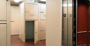 A row of white lockers in a room.