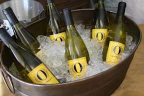 A metal tub filled with ice and six bottles of O'Brien's wine.