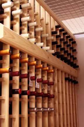 A wine rack with many bottles of wine.
