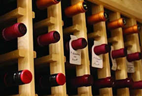 A wine rack with several bottles of wine.